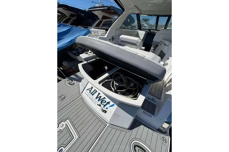 Slide: The Image of 2019 Regal 3350 Sport Cruiser with open storage compartment on deck. - 8