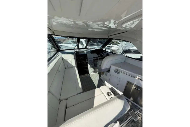 Slide: The Image of 2019 Regal 3350 Sport Cruiser interior with white seating and modern dashboard. - 9