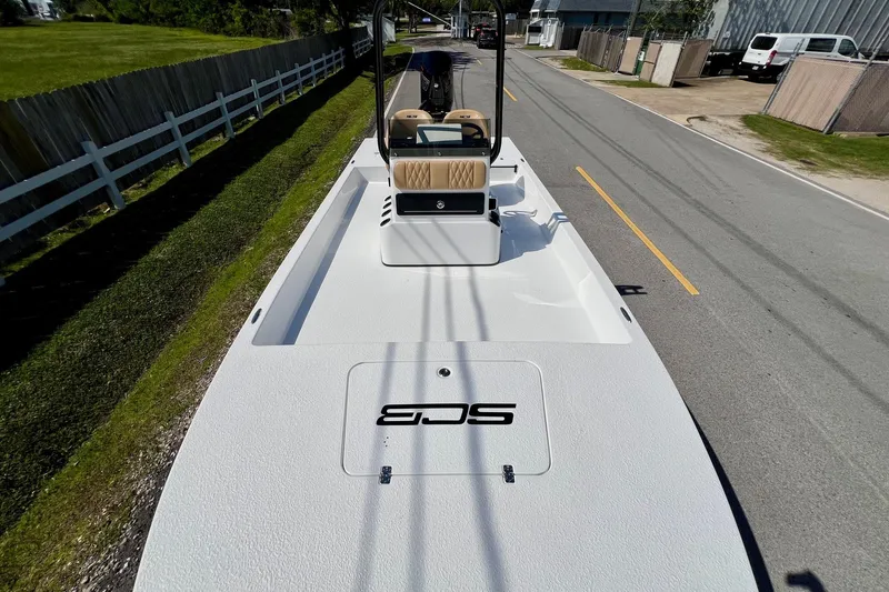 Slide: The Image of 2025 SCB S22 boat on trailer, parked on a suburban street. - 14