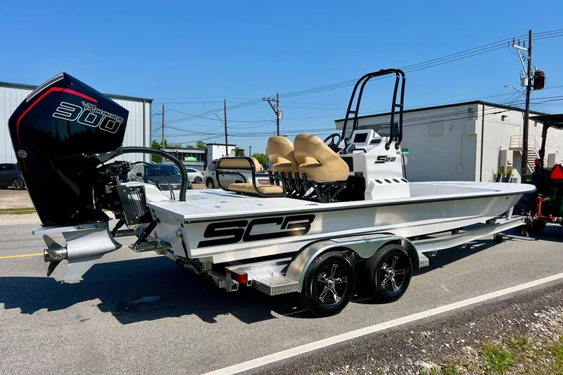 Slide: The Image of 2025 SCB S22 boat with powerful 300 HP engine on a trailer, parked outdoors. - 3