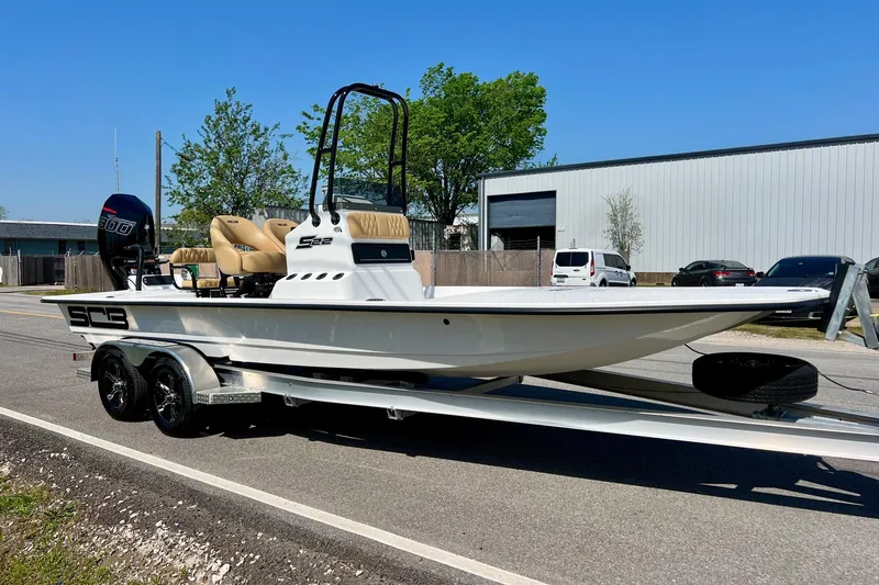 Slide: The Image of 2025 SCB S22 boat on trailer, parked outdoors, featuring sleek design and powerful engine. - 4