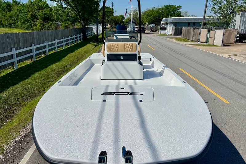 Slide: The Image of 2025 SCB S22 boat on a road, showcasing sleek design and spacious deck. - 5