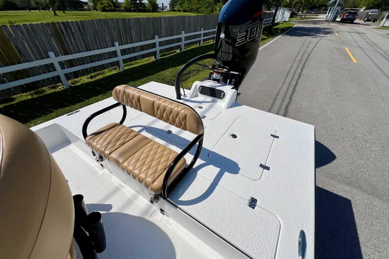 Slide: The Image of 2025 SCB S22 boat with tan seating and powerful outboard motor on a sunny day. - 6