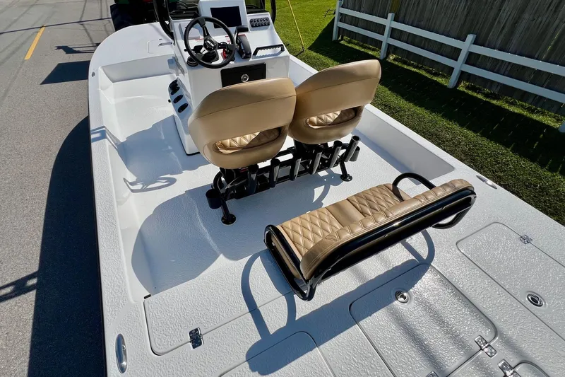 Slide: The Image of 2025 SCB S22 boat interior with tan seating and steering console. - 7
