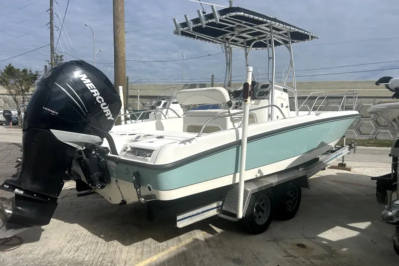 The Image of 2012 Boston Whaler 230 Dauntless boat with Mercury Verado engine on trailer. - 0