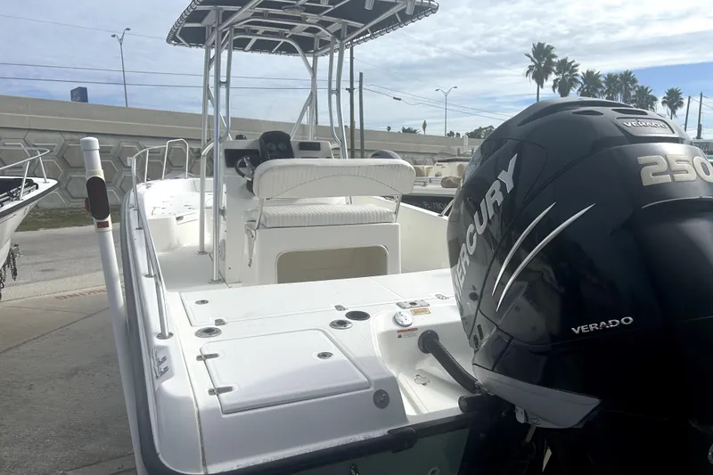 Slide: The Image of 2012 Boston Whaler 230 Dauntless boat with Mercury Verado 250 engine, docked outdoors. - 4