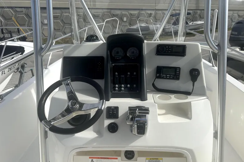 Slide: The Image of Steering console of 2012 Boston Whaler 230 Dauntless boat with controls and gauges. - 8