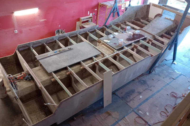 Slide: The Image of Custom Passenger Catamaran BYD34 2026 under construction in a workshop setting. - 5