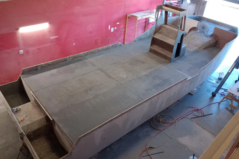 Slide: The Image of Custom Passenger Catamaran BYD34 2026 under construction in a workshop setting. - 6