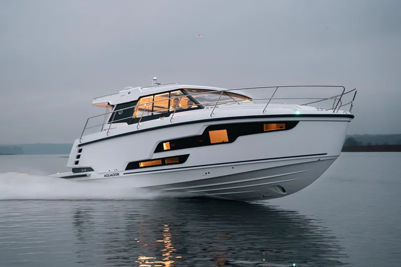 Slide: The Image of 2026 Aquador 400HT luxury yacht cruising on calm waters at dusk. - 0