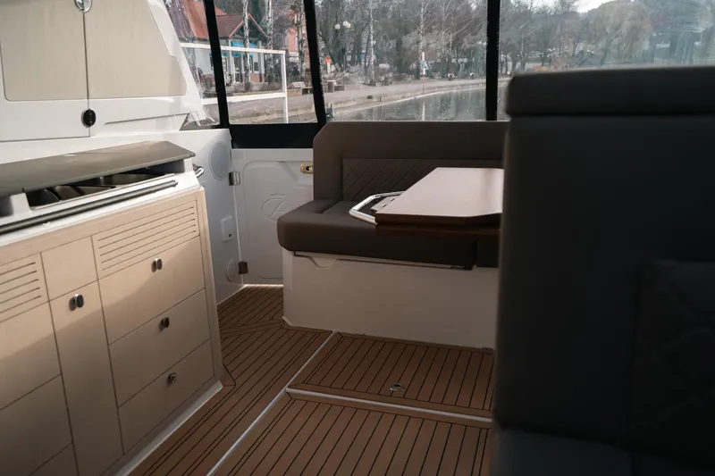 Slide: The Image of Interior of 2026 Aquador 400HT boat with modern seating and cabinetry. - 11