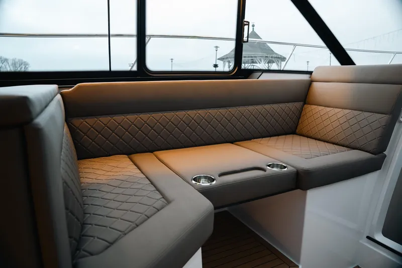 Slide: The Image of Luxurious interior seating of 2026 Aquador 400HT boat with quilted upholstery and cup holders. - 12