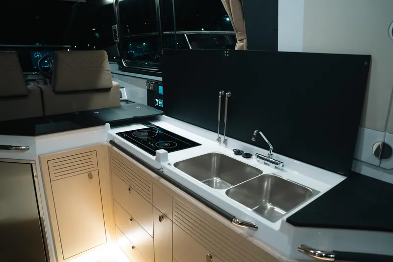 Slide: The Image of Modern kitchen interior of 2026 Aquador 400HT yacht with dual sinks and induction cooktop. - 14