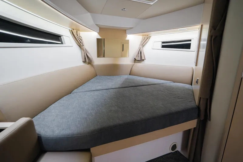 Slide: The Image of Luxurious cabin interior of 2026 Aquador 400HT yacht with modern bedding and windows. - 15