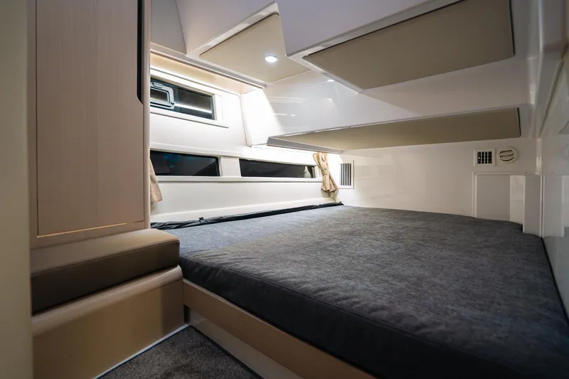 Slide: The Image of Modern interior cabin of 2026 Aquador 400HT boat with sleek design and comfortable bedding. - 16