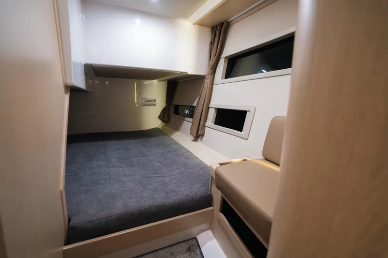 Slide: The Image of Interior cabin of 2026 Aquador 400HT boat, featuring a cozy bed and modern design. - 20