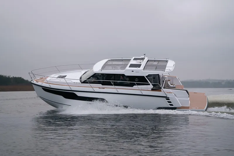 Slide: The Image of 2026 Aquador 400HT cruising on a calm lake under overcast skies. - 3