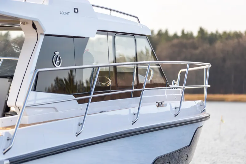 Slide: The Image of 2026 Aquador 400HT boat on water, showcasing sleek design and modern features. - 6