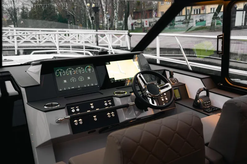 Slide: The Image of Interior view of 2026 Aquador 400HT yacht cockpit with modern navigation controls. - 7