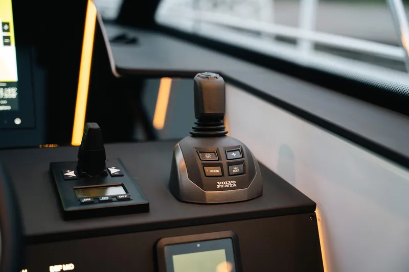 Slide: The Image of Control panel of 2026 Aquador 400HT boat featuring Volvo Penta joystick. - 8