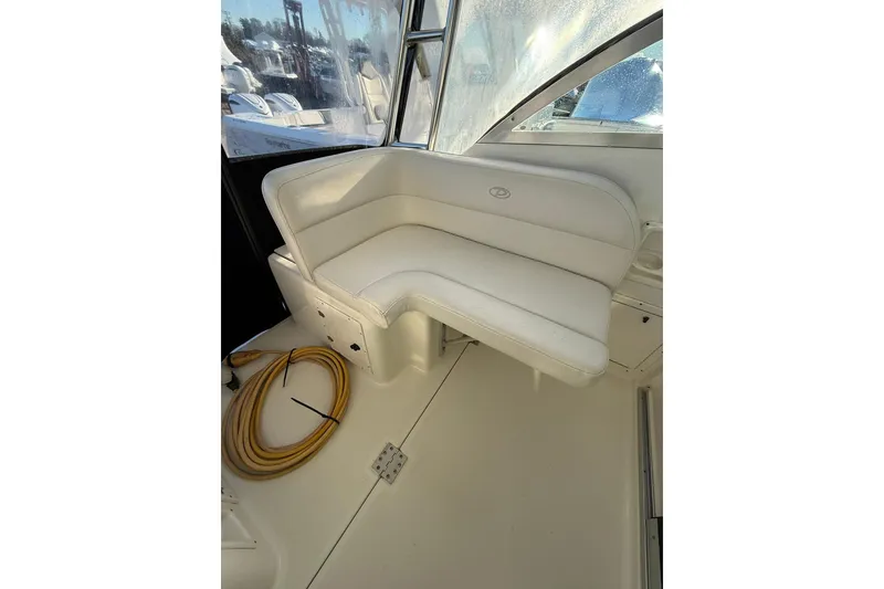 Slide: The Image of 2005 Pursuit 3070 Offshore boat interior with white seating and coiled rope. - 11