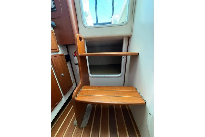 Slide: The Image of Wooden steps inside a 2005 Pursuit 3070 Offshore boat cabin. - 17