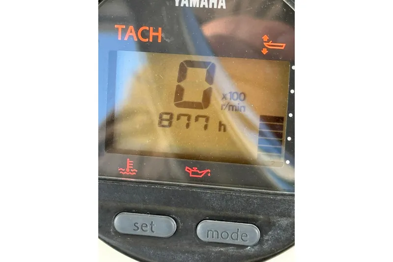 Slide: The Image of Yamaha tachometer displaying 877 hours on a 2005 Pursuit 3070 Offshore boat. - 18