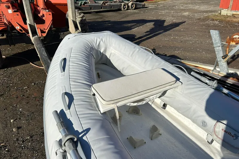 Slide: The Image of Inflatable Caribe C9 boat, 2005 model, with seating, parked on gravel. - 4