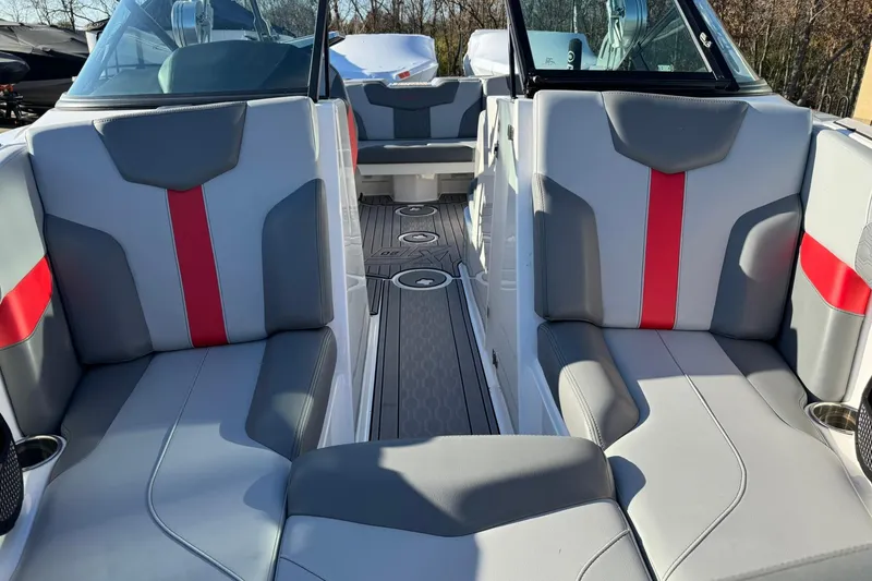 Slide: The Image of 2023 MasterCraft XT20 boat interior with gray and red seating, modern design. - 5