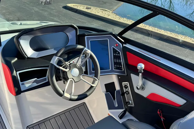 Slide: The Image of 2023 MasterCraft XT20 boat dashboard with modern steering and control panel. - 8