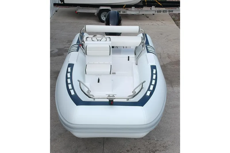 Slide: The Image of 2025 Novurania DL 460 boat with Yamaha engine in showroom setting. - 2