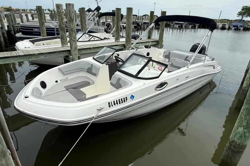 The Image of 2023 Bayliner VR6 Bowrider OB docked at marina, featuring sleek design and spacious seating. - 1