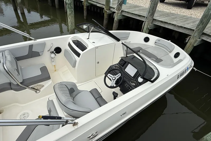 Slide: The Image of 2023 Bayliner VR6 Bowrider OB, sleek interior design, docked at marina. - 4