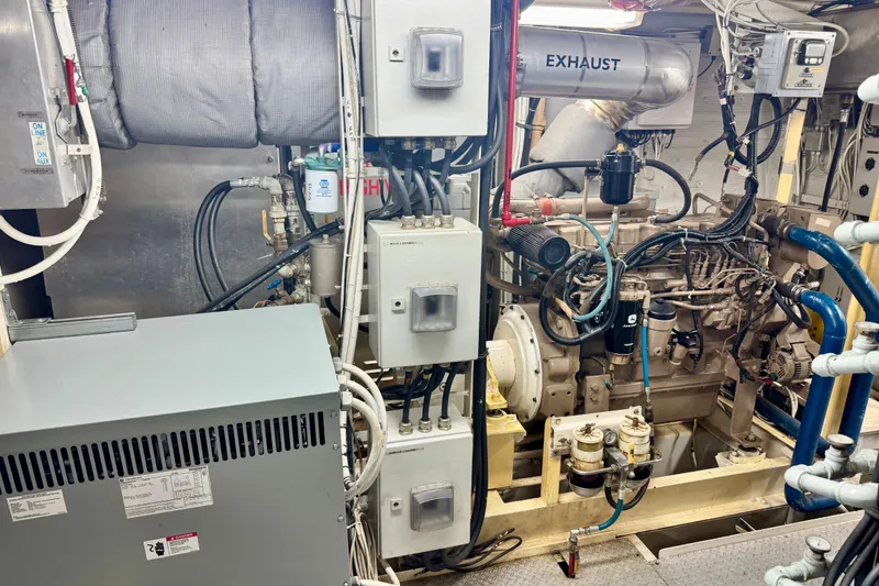 Slide: The Image of Engine room of a 2016 Custom Commercial Research Riverboat, showcasing complex machinery and exhaust system. - 14