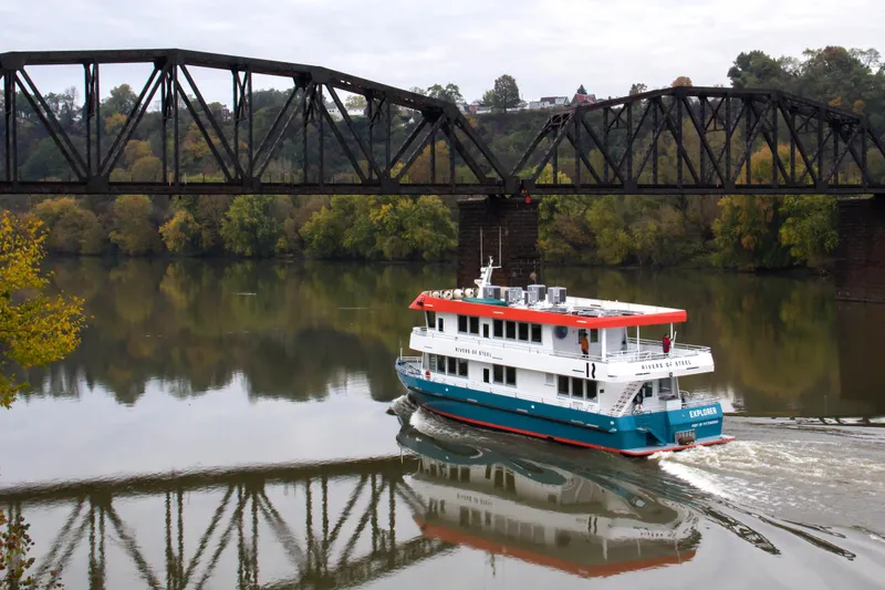Slide: The Image of Custom 2016 commercial research riverboat cruising under a steel bridge on a scenic river. - 2