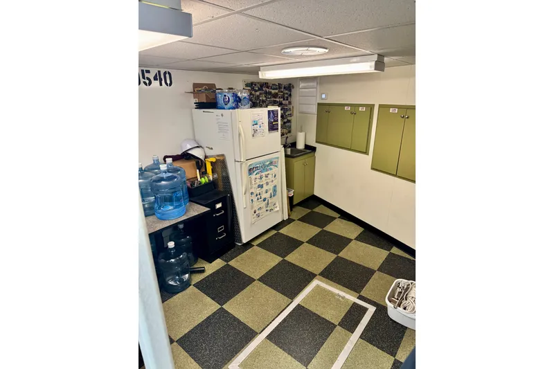 Slide: The Image of Interior of 2016 custom commercial research riverboat with checkered floor and storage cabinets. - 9