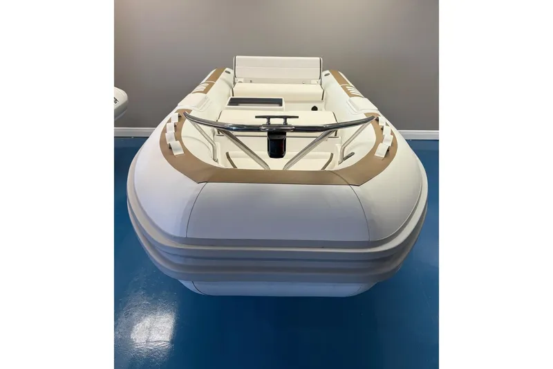 Slide: The Image of 2025 Novurania DL 400 inflatable boat displayed indoors with contact information. - 2