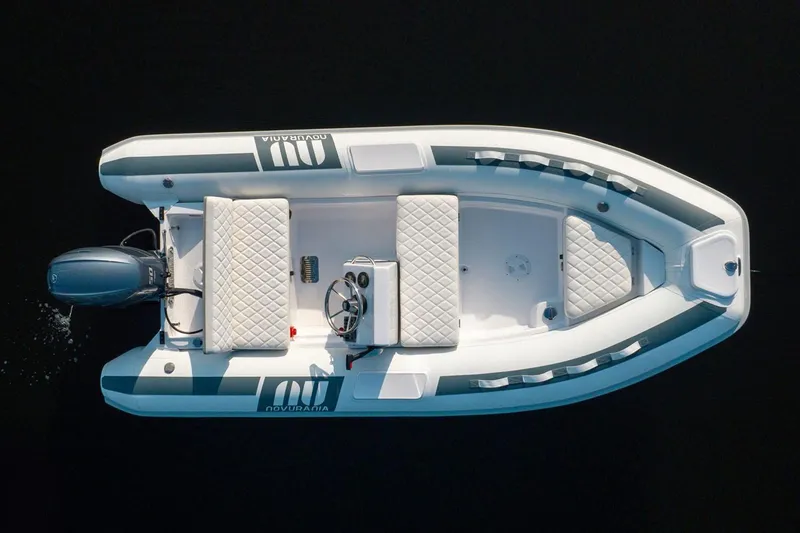 Slide: The Image of 2025 Novurania DL 400 boat interior with steering console and seating. - 6