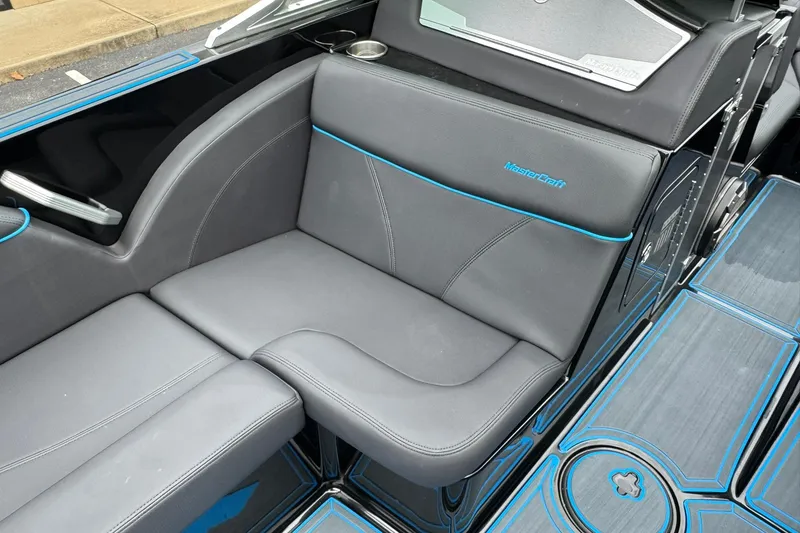 Slide: The Image of 2018 MasterCraft X23 boat interior with gray and blue seating. - 10