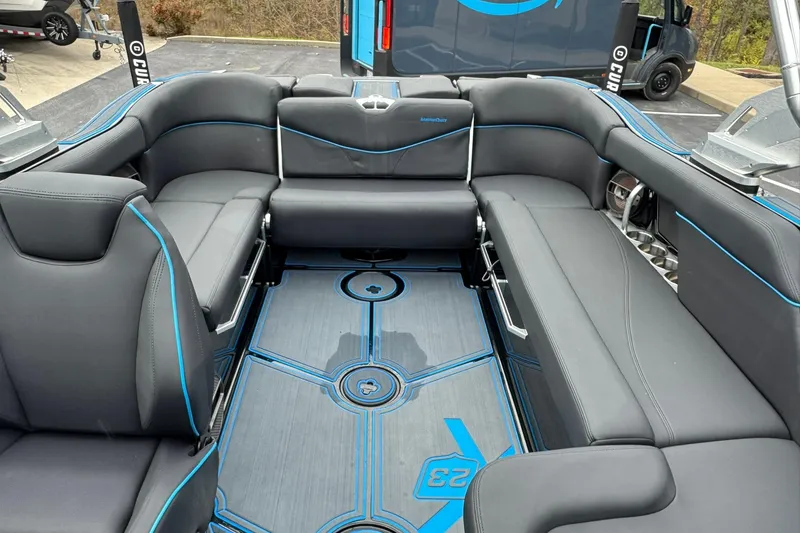 Slide: The Image of 2018 MasterCraft X23 boat interior with sleek gray seating and blue accents. - 11