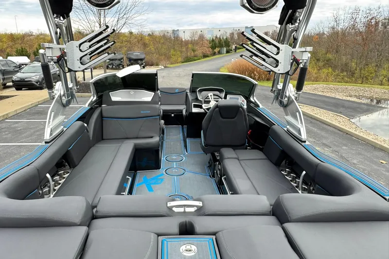 Slide: The Image of 2018 MasterCraft X23 boat interior with sleek seating and advanced wakeboard racks. - 12