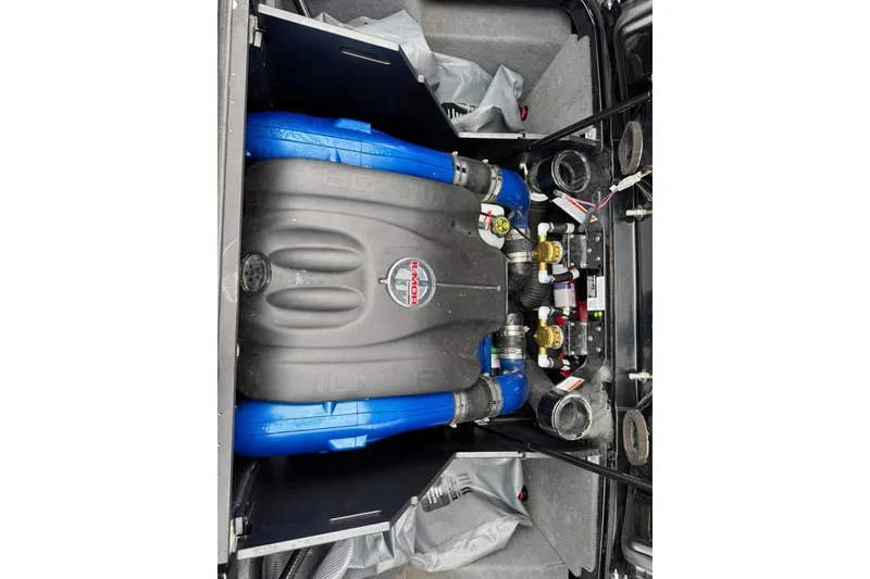 Slide: The Image of 2018 MasterCraft X23 engine compartment with Ilmor engine and blue hoses. - 14