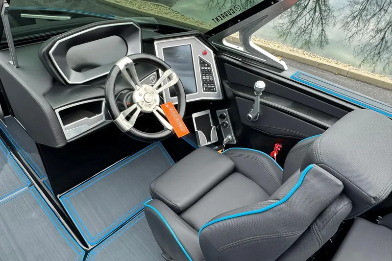 Slide: The Image of 2018 MasterCraft X23 boat interior with modern steering wheel and dashboard controls. - 9