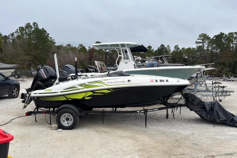 The Image of 2022 Tahoe T16 boat on trailer in outdoor storage area. - 1