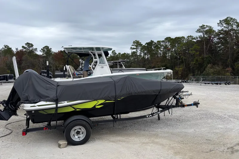 Slide: The Image of 2022 Tahoe T16 boat covered on trailer in outdoor storage area. - 10