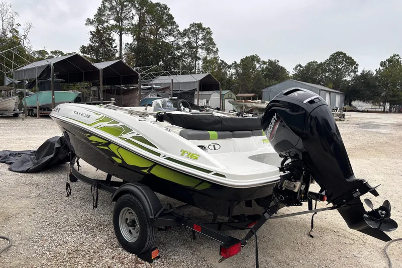 Slide: The Image of 2022 Tahoe T16 boat with Mercury outboard motor on a trailer in a storage area. - 7
