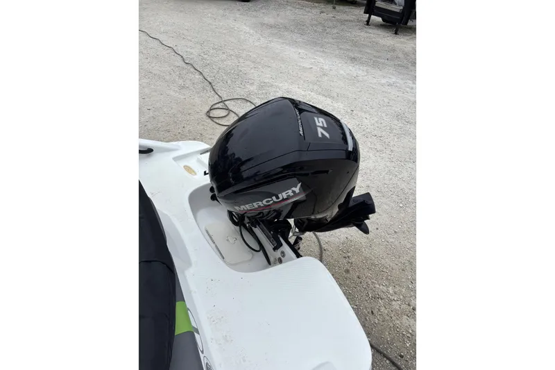 Slide: The Image of 2022 Tahoe T16 boat with Mercury 75 outboard motor on a gravel surface. - 9