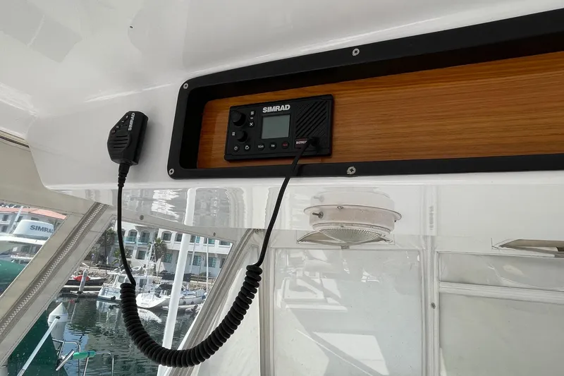 Slide: The Image of Simrad marine radio on 1986 Ocean 38 Super Sport boat, docked at marina. - 19