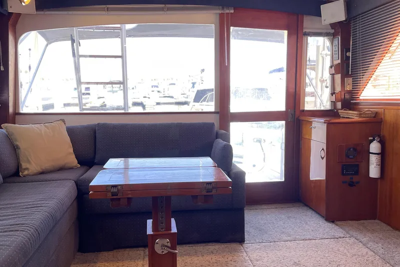 Slide: The Image of Interior of 1986 Ocean 38 Super Sport yacht with cozy seating and wooden accents. - 2