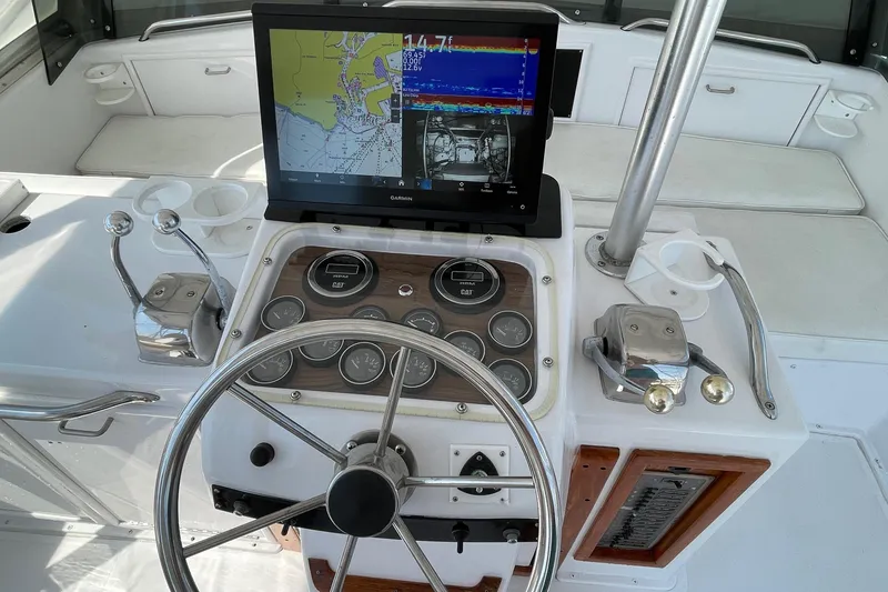 Slide: The Image of 1986 Ocean 38 Super Sport helm with Garmin navigation display and classic controls. - 21